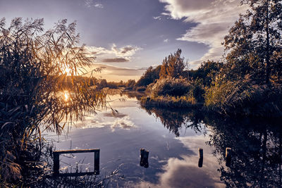 Scenic view of lake against sky during sunset