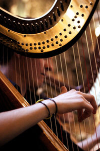 Close-up of musician playing harp