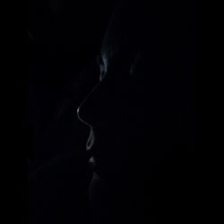 Rear view of woman in dark room