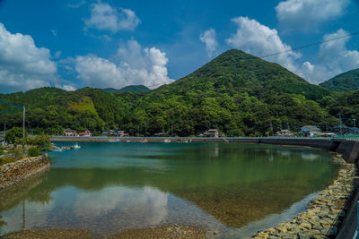 Scenic view of lake and mountains against sky