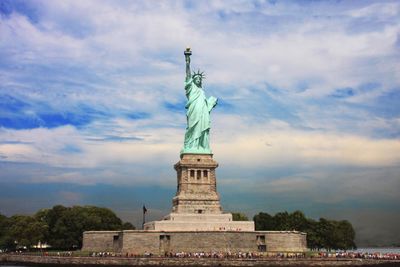 Statue of liberty against cloudy sky