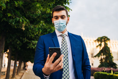 Portrait of young man using mobile phone