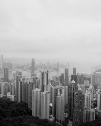 Aerial view of buildings in city against sky