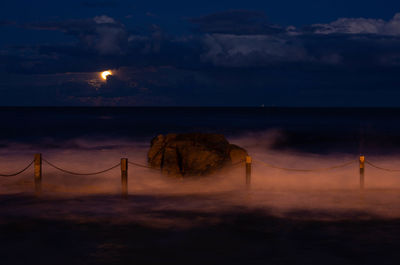 Scenic view of sea against sky at night