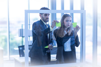 Man and woman standing in front of office