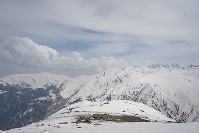 Scenic view of snow covered mountains against sky