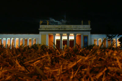 Illuminated building against sky at night