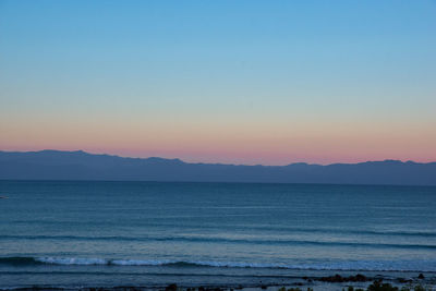 Scenic view of sea against clear sky during sunset