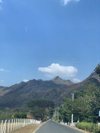 Road amidst mountains against sky