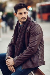 Portrait of young man sitting outdoors