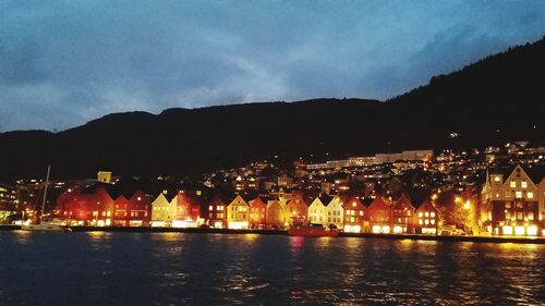 Illuminated city against sky at night