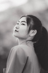 Portrait of a young woman looking away