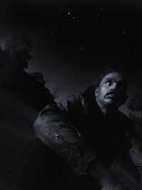 Portrait of young man looking at night
