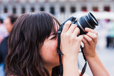 Close-up portrait of woman photographing