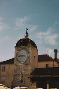 Low angle view of clock tower against sky