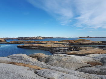 Scenic view of beach against blue sky