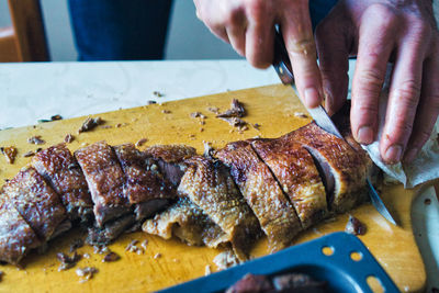 Close-up of person preparing food on cutting board