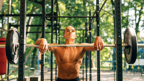 Midsection of man skateboarding in park