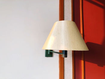 Close-up of electric lamp against wall