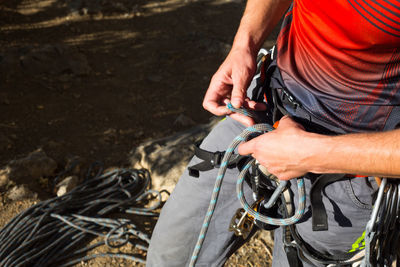 Midsection of man working with rope