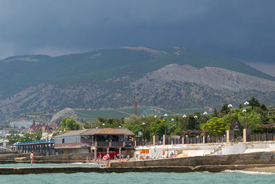 Scenic view of sea and mountains against sky