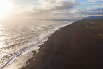 Scenic view of beach against sky during sunset