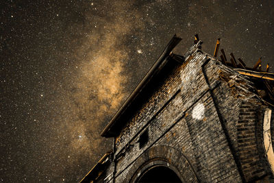 Low angle view of old building against sky at night
