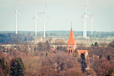 Church and windmill in village