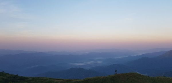 Scenic view of silhouette mountains against sky during sunset