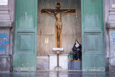 Statue against door of building