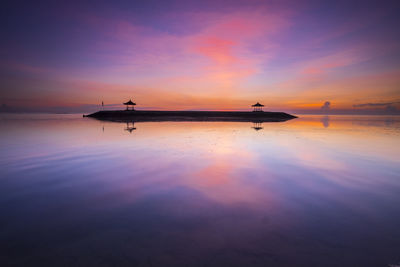 Silhouette man on boat in sea against sky during sunset