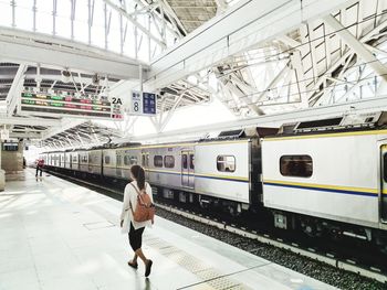 Full length of woman walking at railroad station