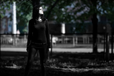 Full length of young woman standing outdoors