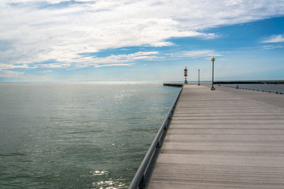 Pier over sea against sky- in early evening light - horizon on water