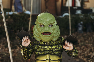 Portrait of boy dressed as sea monster posing in costume at halloween