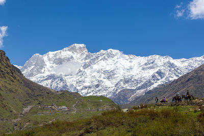 Scenic view of snowcapped mountains against blue sky on the way to kedarnath
