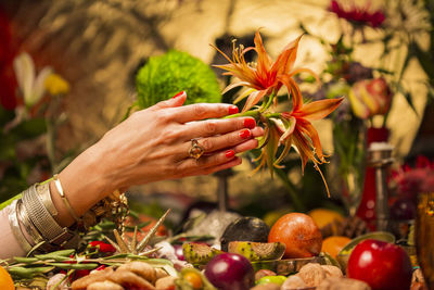 Close-up of hand holding red berries on plant