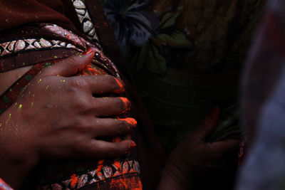 Midsection of woman hand covered in powder paint