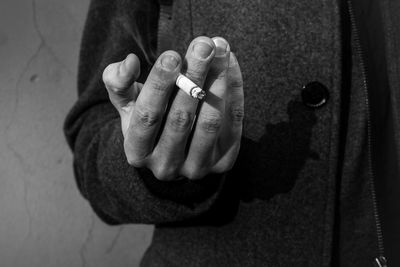 Close-up midsection of man smoking cigarette