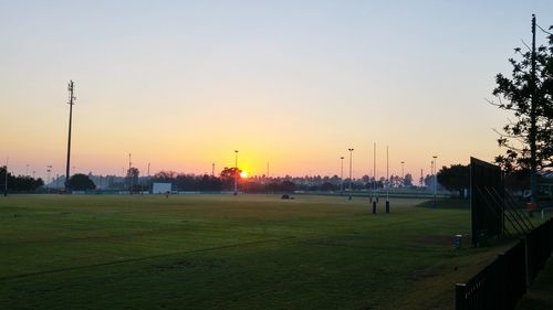 Scenic view of landscape against clear sky during sunset