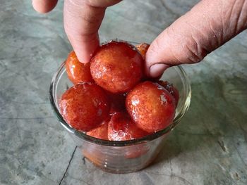 High angle view of person holding strawberries