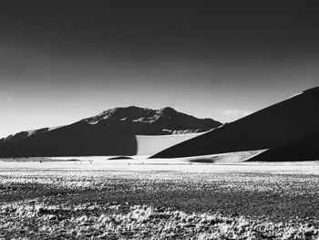Scenic view of snowcapped mountains against clear sky