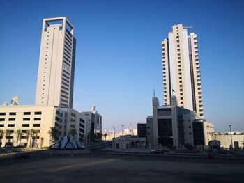 Modern buildings against clear blue sky