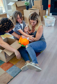 Happy woman sitting on floor