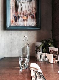 Glass of bottles on table at restaurant