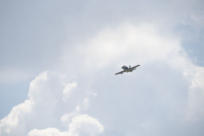 Low angle view of airplane flying in sky