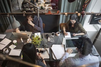 High angle view of people working on table