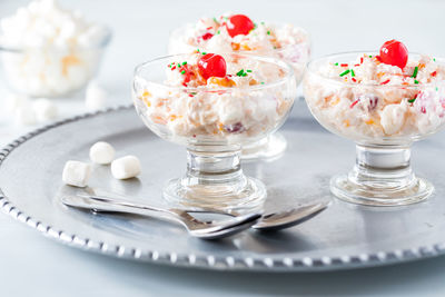 Three dishes filled with ambrosia salad.