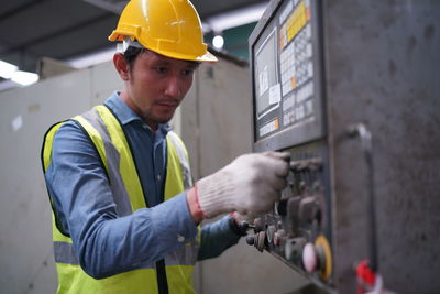 Rear view of man working at construction site