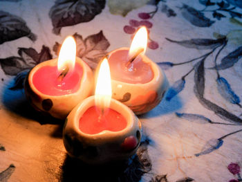 High angle view of burning candle